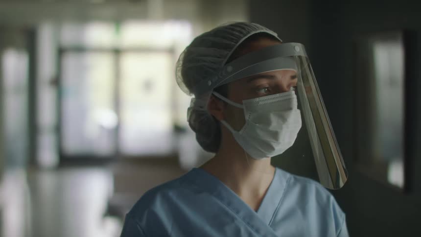 A doctor walks down the hall in the hospital