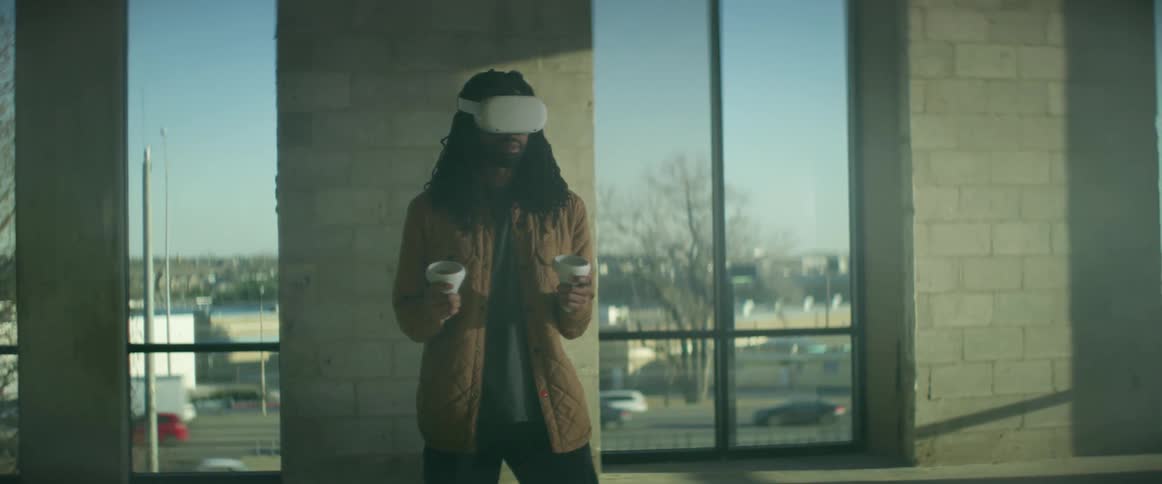 A man is playing virtual reality inside a building