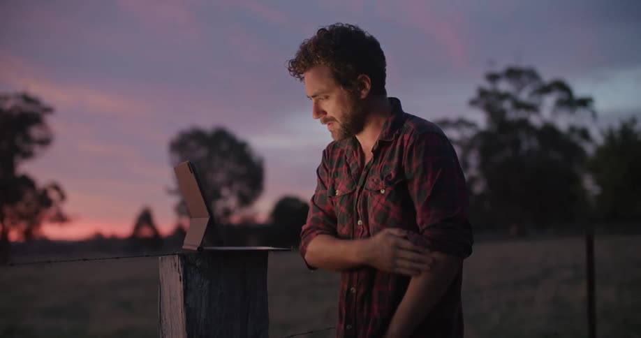 A man using a tablet outdoors