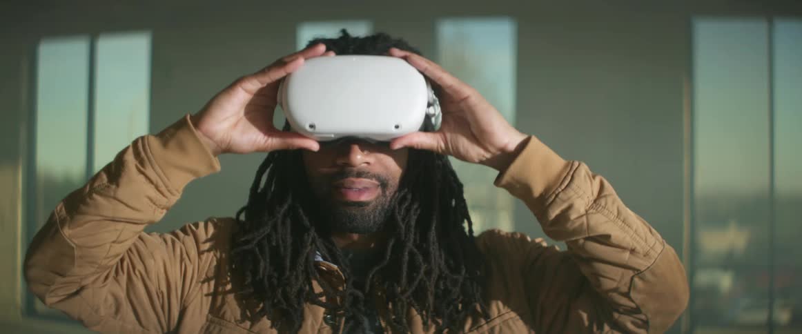 A man taking off a virtual reality headset