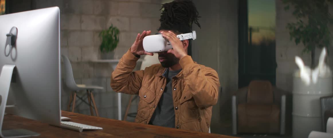 A man putting on a virtual reality headset