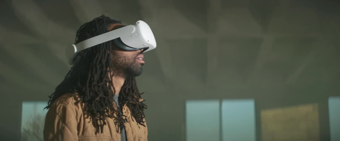 A man is using a virtual reality headset inside
