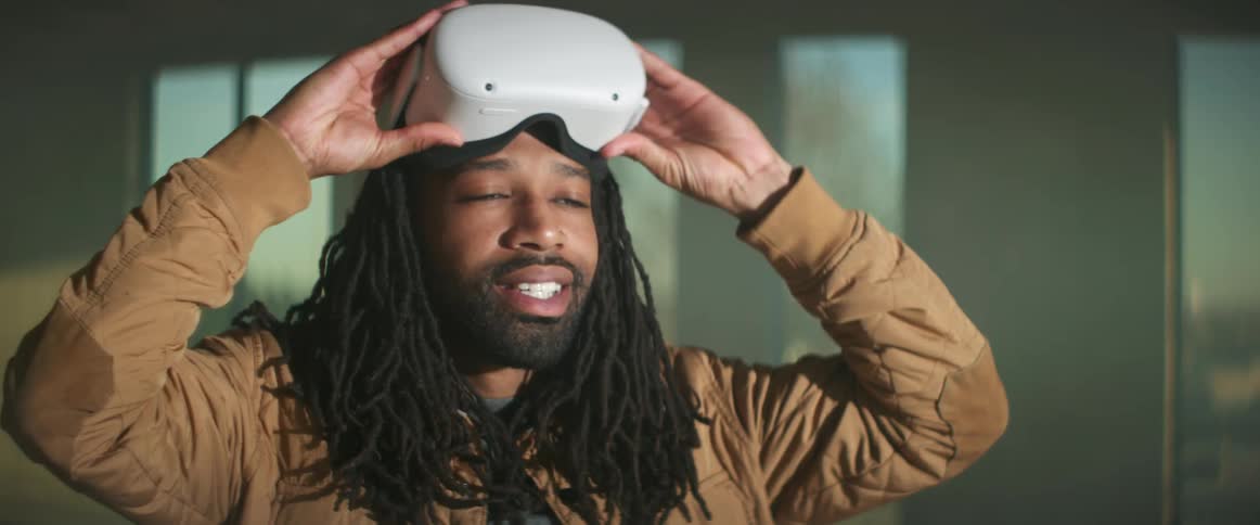 A man lowers his virtual reality headset
