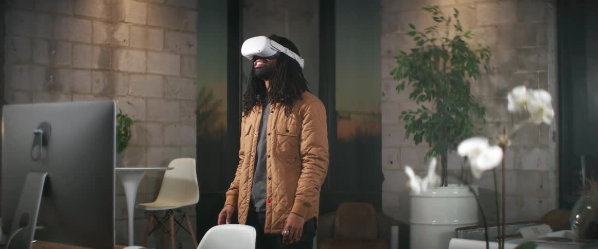 A man putting on a virtual reality headset