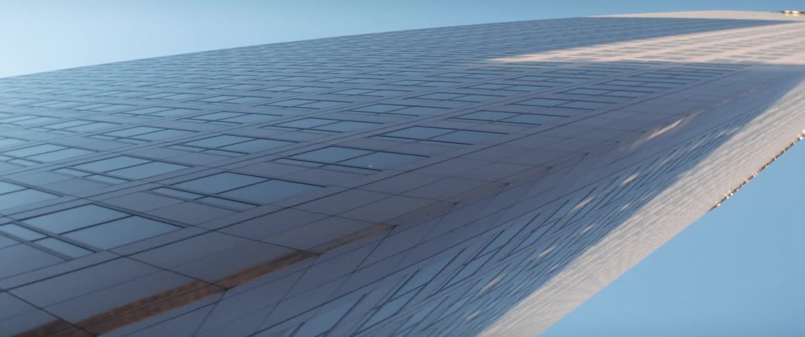 The corner of a skyscraper at an odd perspective on a sunny day