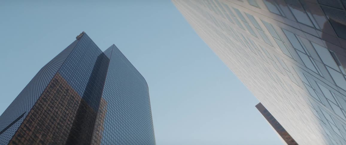 The tall buildings reflect the sunlight