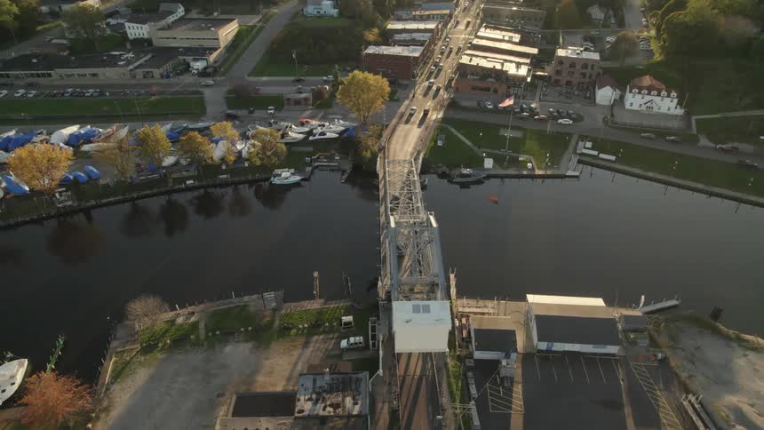 Aerial view of vehicles crossing bridge over river