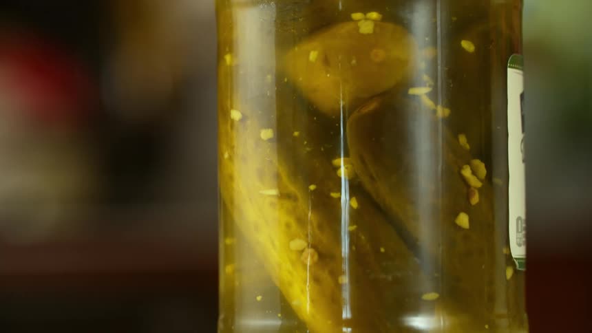 Pickle seasonings fall toward the bottom in a pickle jar