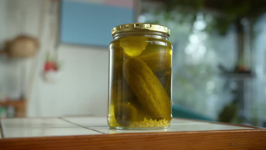 Unopened pickle jar sits on tiled counter