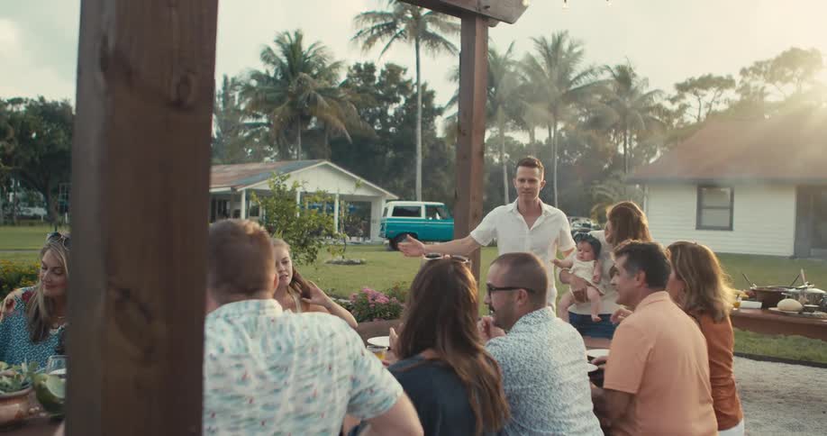 People have drinks outside at a gathering