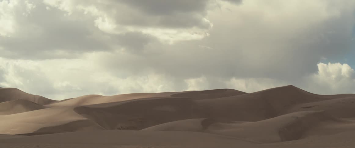 The desert has heavy clouds above