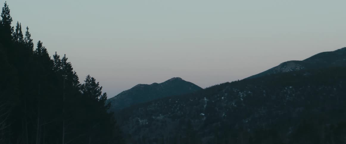 The sun is setting on the mountain
