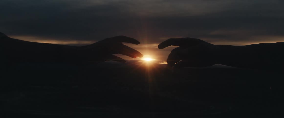 A view of two people reaching out for each other