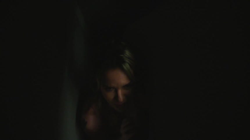 A woman is stuck in a small dark room