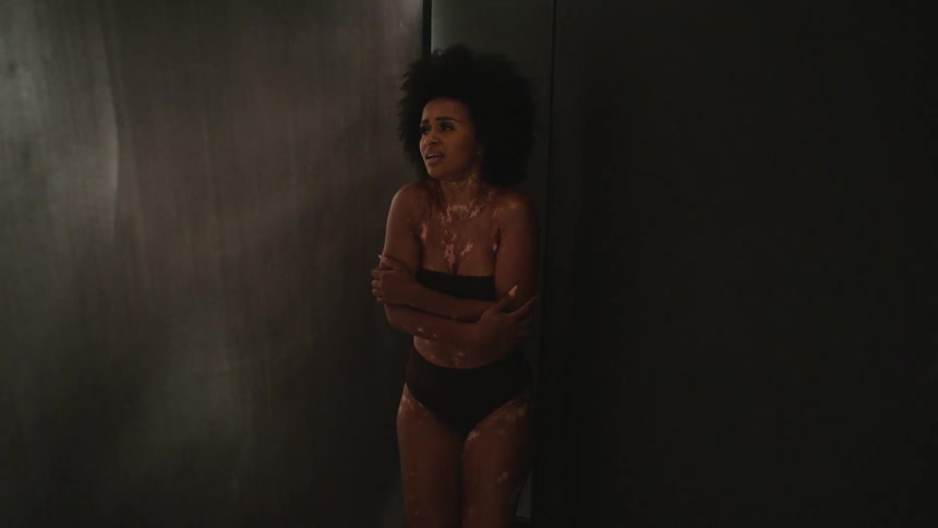 A scared woman covers up her body in the room