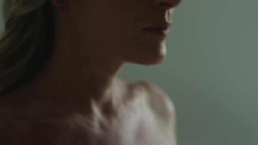 Close up of the bottom of a womans face and her bare neck