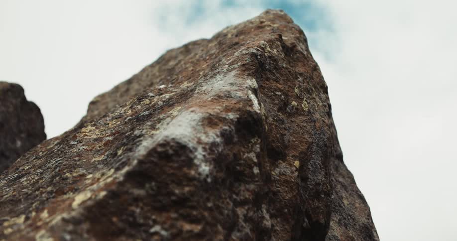 White debris sits on the side of a tall granite rock formation