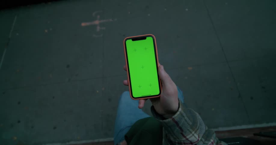 A man waiting pulls out his phone checks it then puts it away