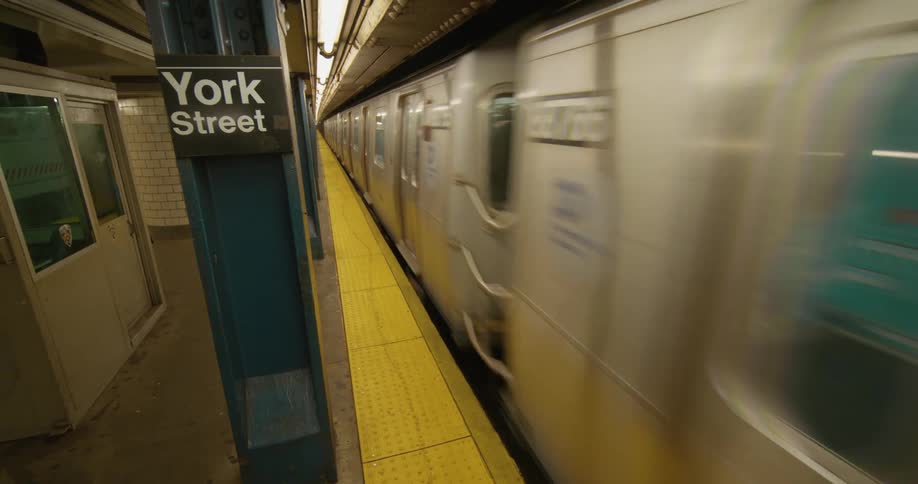 A woman walks to the terminal as the train passes