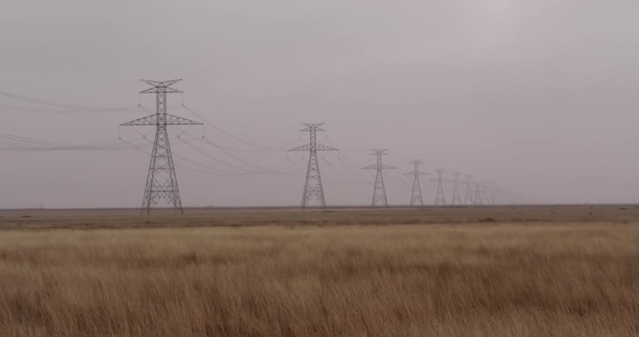 Electrical towers on a grassy plain