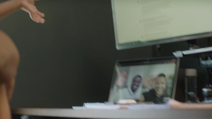 Father holds son as they video call with two other people