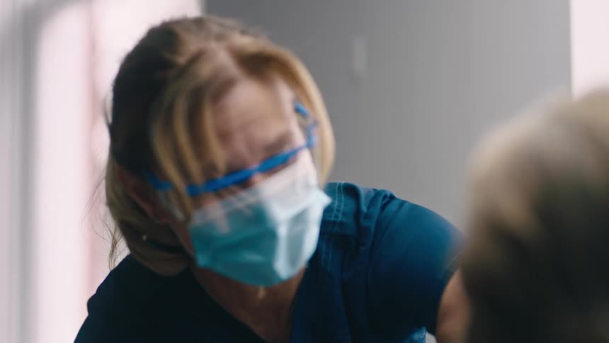Nurse gives patient an injection