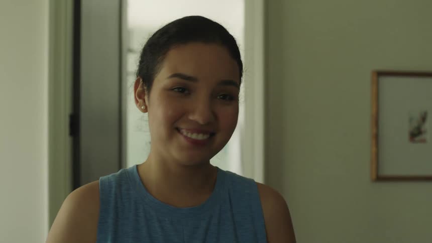 A woman smiles and shakes her head