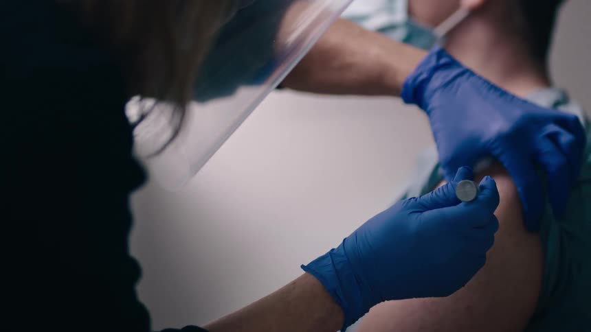 Nurse give patient an injection in the arm