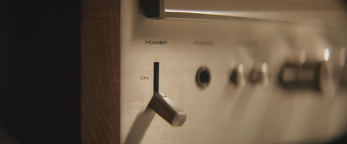A hand turns on the power switch of an electronic device