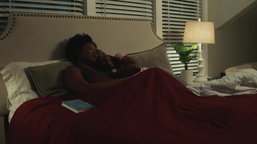 A couple are in bed together