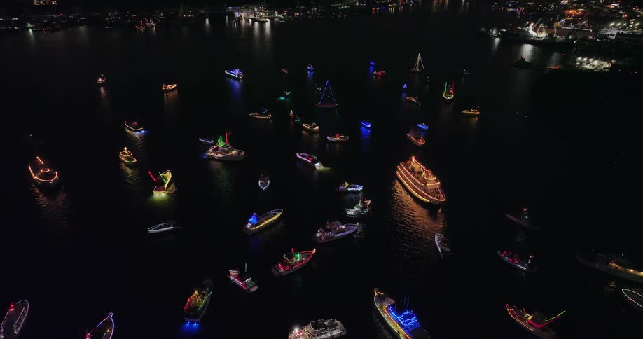 High overview over a large group of boats decorated in colorful Christmas lights gathered near Gasworks Park