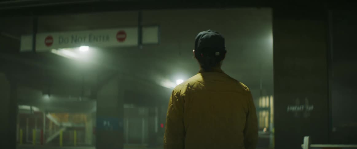 White man walking around at an empty parking lot