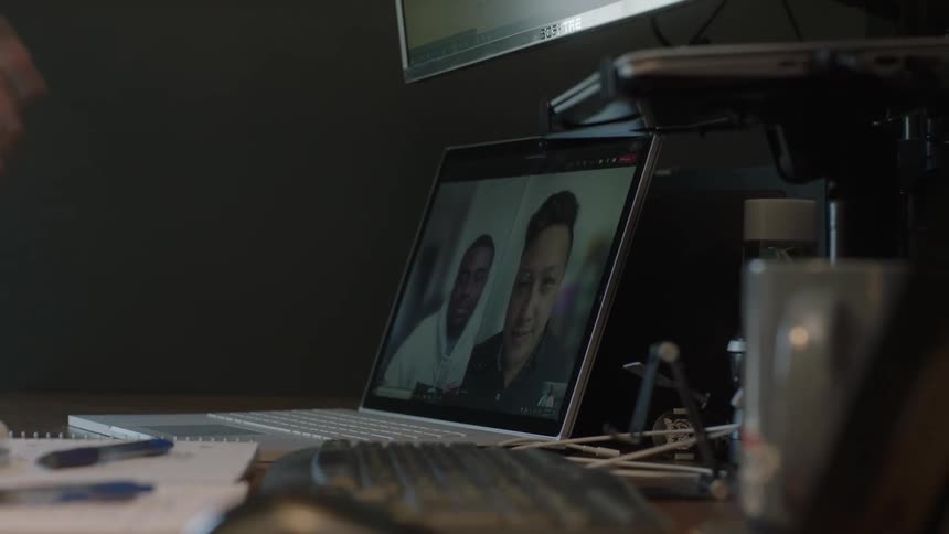 Three men talking over video call in the daytime