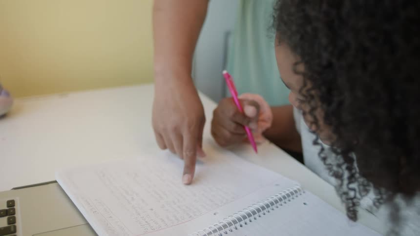 A child is doing homework using a notebook