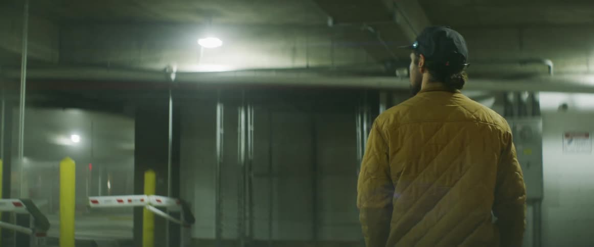 A man walks into the parking garage