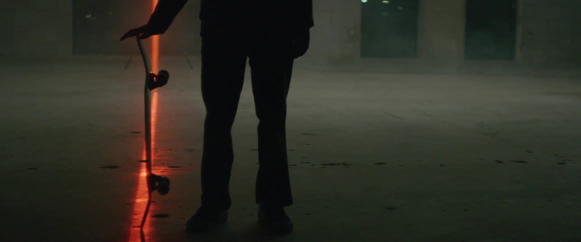 A man twists his skateboard back and forth