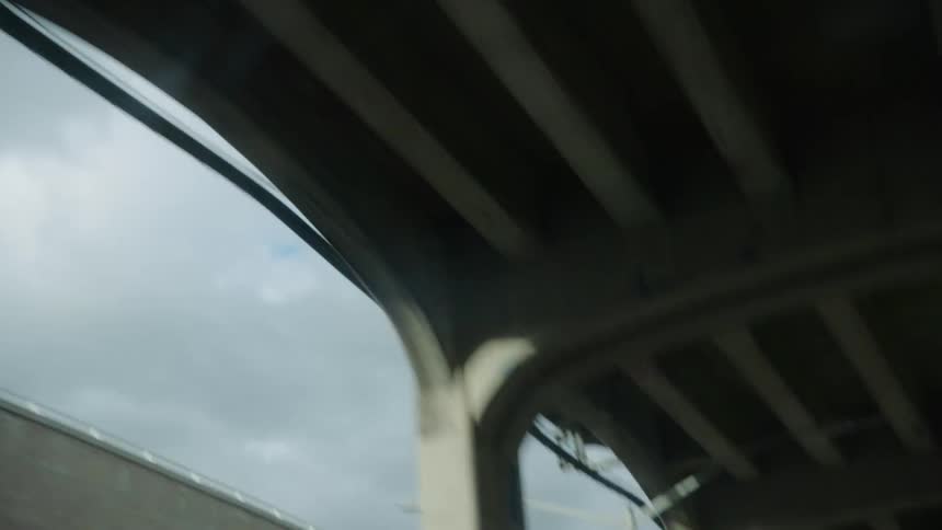 A building is by the overpass of the train platform