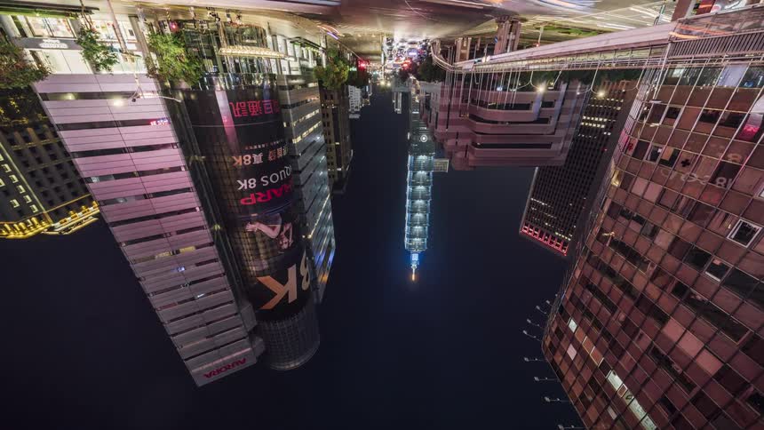 City lights flash on and off as heavy traffic passes through downtown