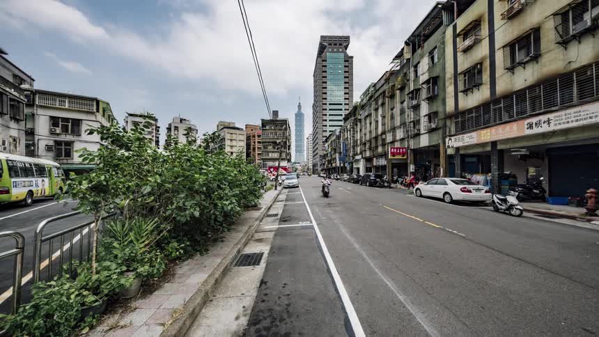 Pedestrians and vehicles travel on the city roads