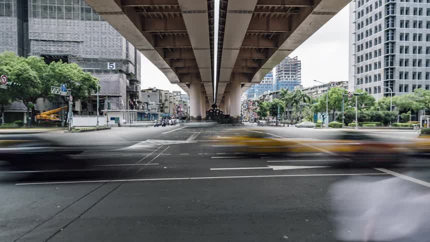 Traffic moves under downtown overpass near construction site