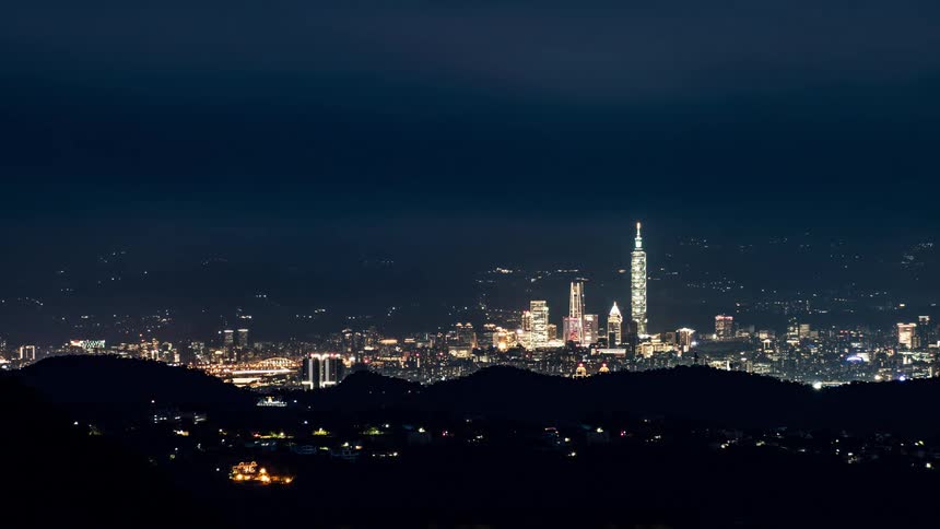 Time lapse footage of night falling over the skyline of the city of taipei