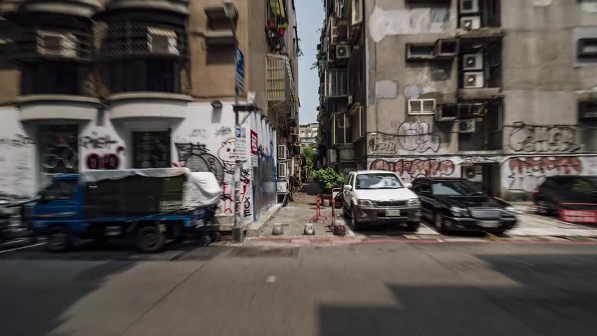 Traffic flows along alley reaching intersection