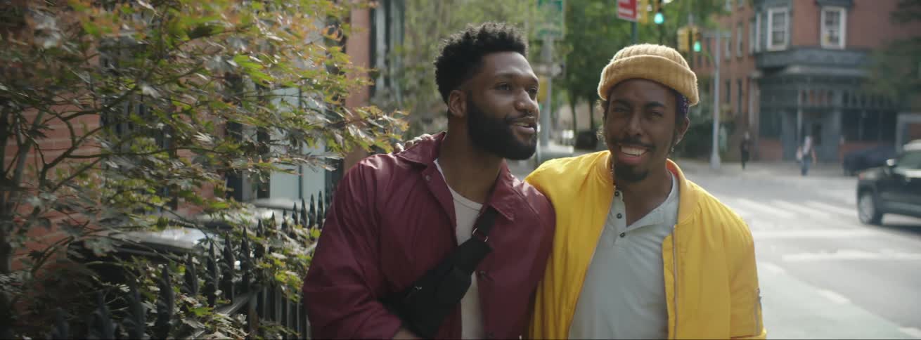 Two men walk together in town