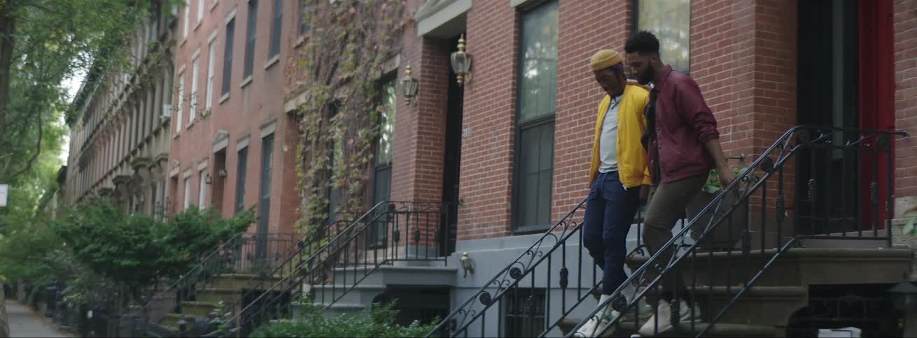 Two friends walking out of a house