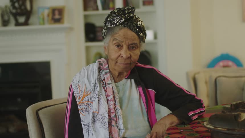 A woman sits at her table