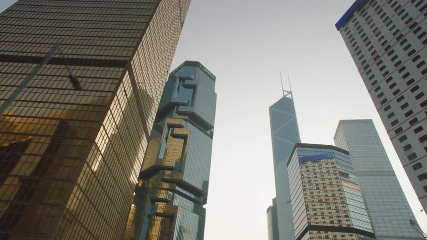Tall skyscrapers towering over a city street in the morning