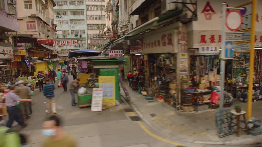 People are outdoors in a city during the day