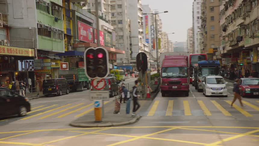 Pedestrians and vehicles travel in the city