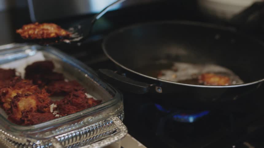 A person is cooking food in a kitchen
