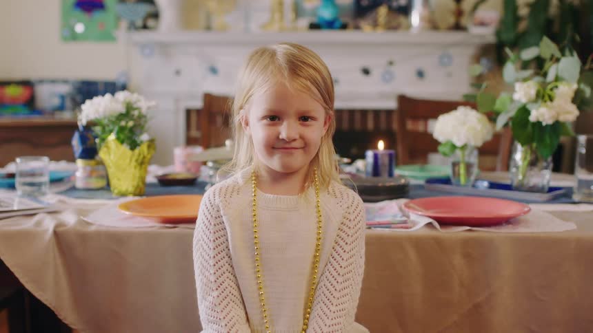 A child is sitting at the kitchen table
